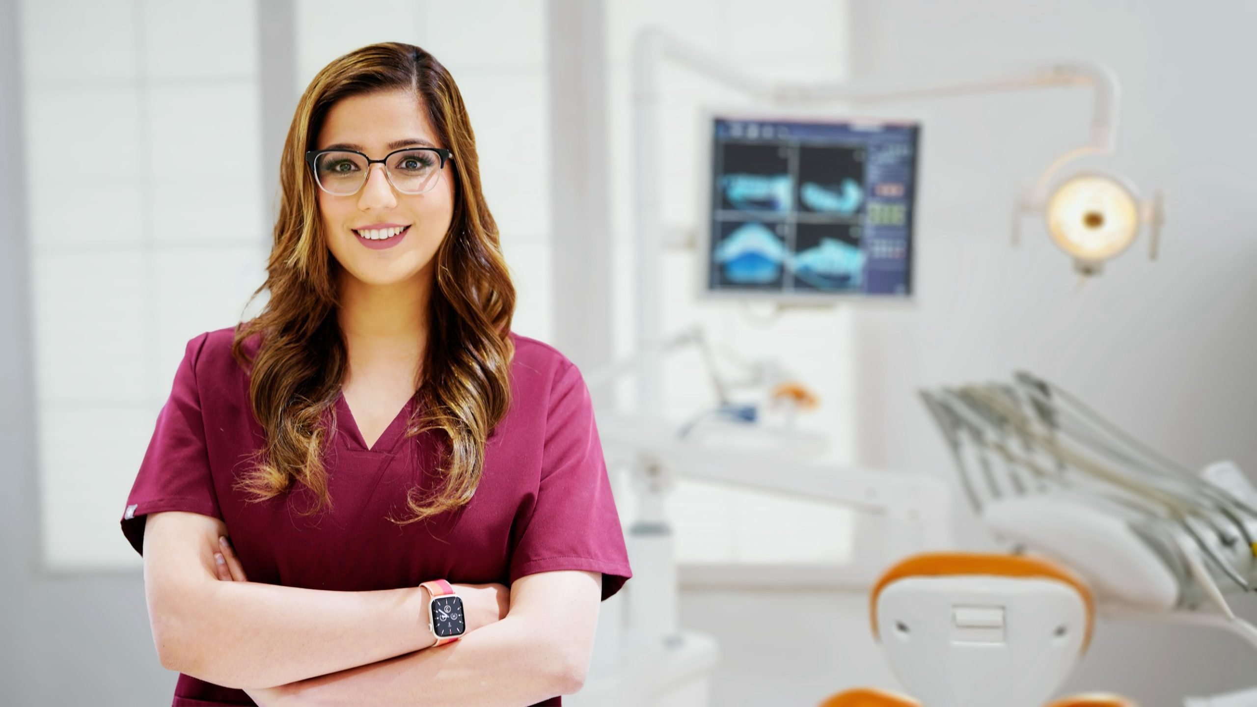 Professional portrait of Dr. Qurrat-ul-Anne Yousaf in her clinic. Expert Falls Church Dentist for quality dental care