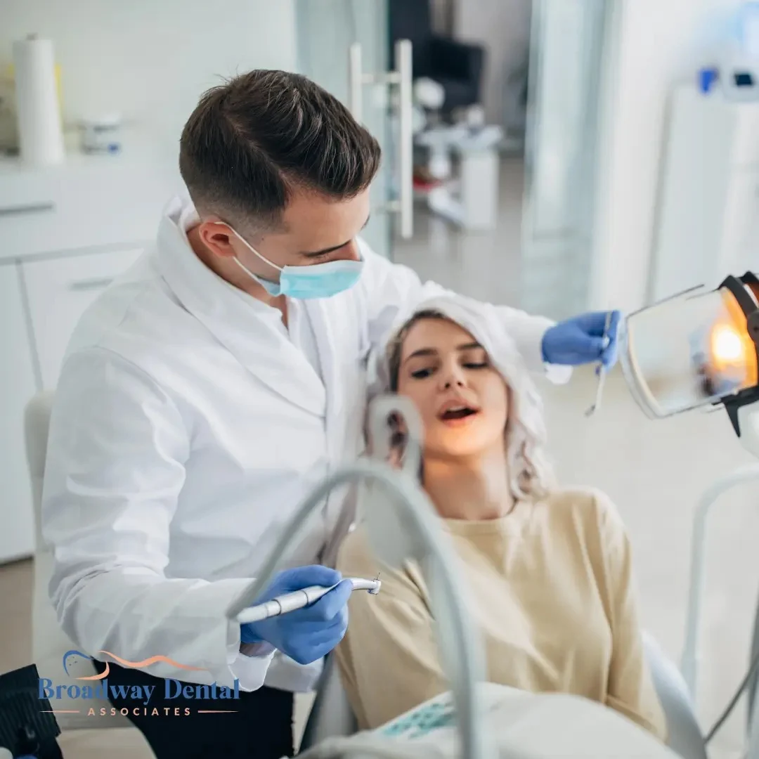 A male dentist examines a patient, highlighting the Importance of Regular Check-Ups and Broadway Dental Associates logo in the bottom left of the image.